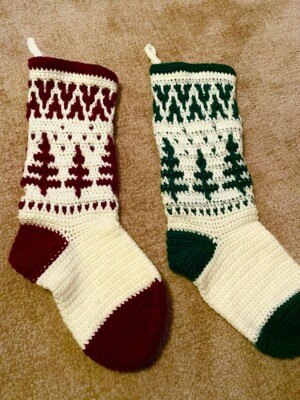 two crochet christmas stockings on a pale tan fluffy bloanket